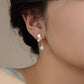 White butterfly shell niche earrings